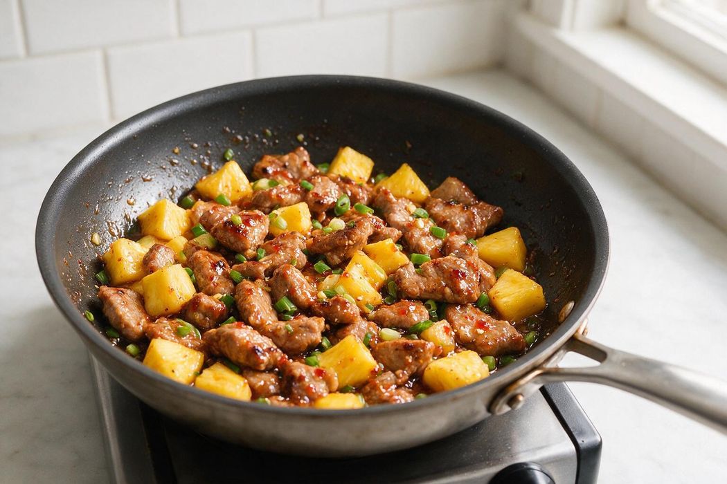 Sweet Chili Pork and Pineapple Skillet step 2: Return pork with green onions, sweet chili sauce, lime juice, and ginger. Toss 1–2 minutes until glossy and hot